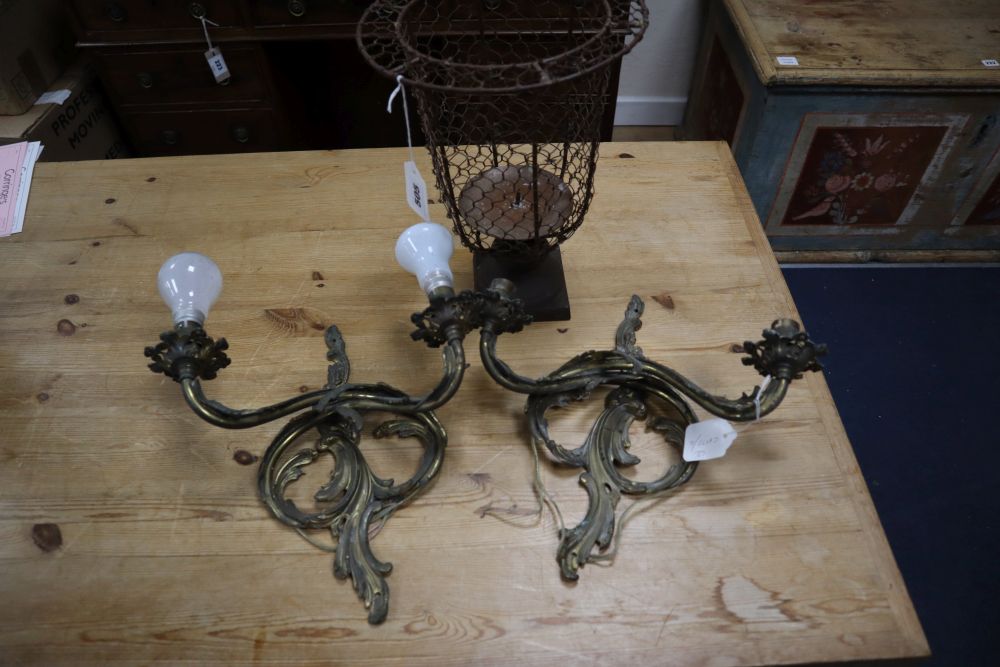 A pair of Louis XV style gilt metal two branch wall lights, and a metal wire framed pricket candle holder, 33cm